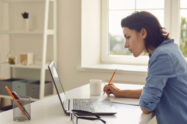 Girl using Laptop studying for PTE Exam