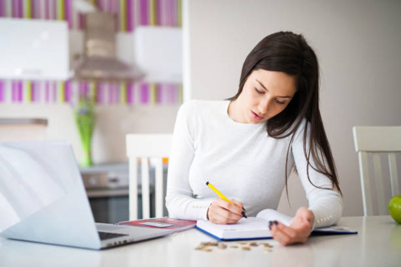 Girl sitting at her desk and Studying for PTE Exam